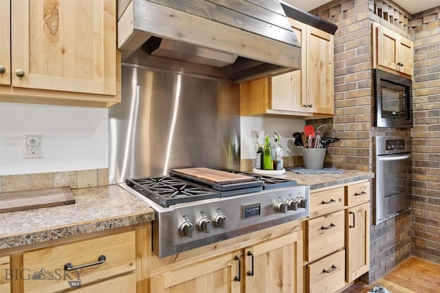915 Point Of Rocks Rd, Whitehall, MT 59759 - kitchen featuring light brown cabinets, stainless steel appliances, extractor fan, dark wood-style floors, and brick wall