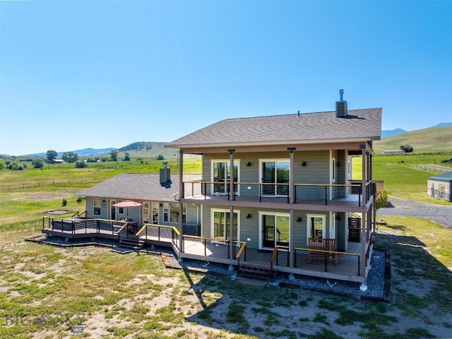 915 Point Of Rocks Rd, Whitehall, MT 59759 - rear view of house featuring a balcony, a rural view, and a deck with mountain view