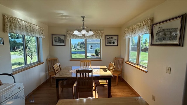 129 E Tobiano Trl, Belgrade, MT 59714 - dining area featuring a chandelier, healthy amount of natural light, and wood finished floors