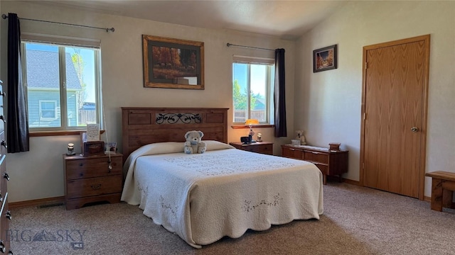 129 E Tobiano Trl, Belgrade, MT 59714 - bedroom with multiple windows, carpet flooring, and vaulted ceiling