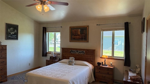 129 E Tobiano Trl, Belgrade, MT 59714 - bedroom with multiple windows, lofted ceiling, and a ceiling fan