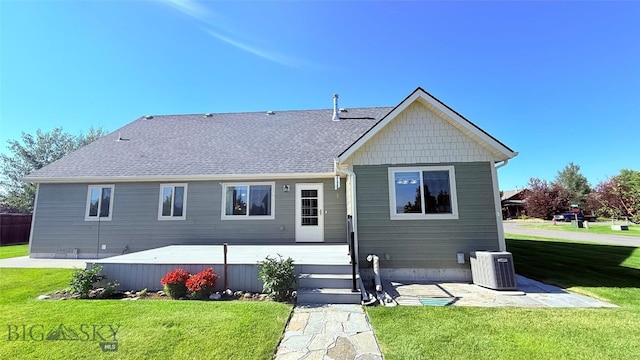 129 E Tobiano Trl, Belgrade, MT 59714 - back of house with a lawn, roof with shingles, and a patio area
