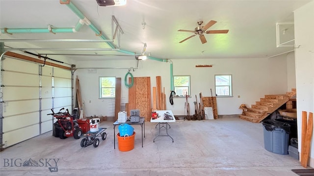 129 E Tobiano Trl, Belgrade, MT 59714 - garage featuring a garage door opener and a ceiling fan