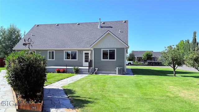129 E Tobiano Trl, Belgrade, MT 59714 - rear view of property with a yard and roof with shingles