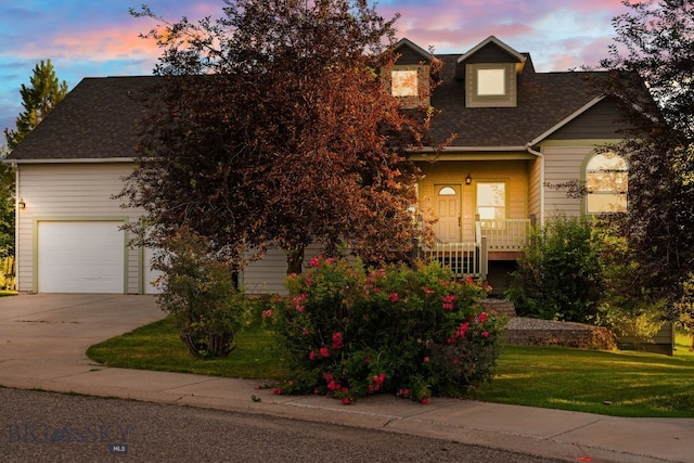 74 W Clara Ct, Bozeman, MT 59718 - view of front facade with concrete driveway, a yard, a shingled roof, and a porch