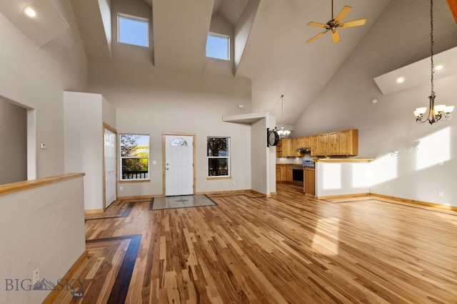 74 W Clara Ct, Bozeman, MT 59718 - unfurnished living room with high vaulted ceiling, a chandelier, light wood-style floors, recessed lighting, and ceiling fan