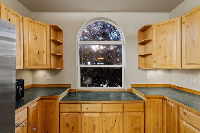 74 W Clara Ct, Bozeman, MT 59718 - kitchen with stainless steel refrigerator, dark countertops, and open shelves