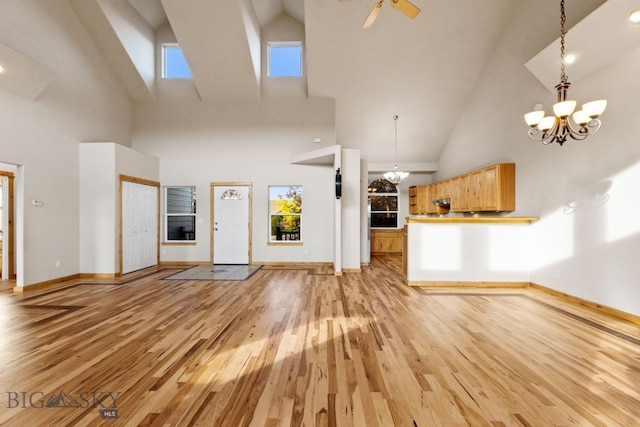74 W Clara Ct, Bozeman, MT 59718 - unfurnished living room featuring high vaulted ceiling, a chandelier, and light wood-style floors