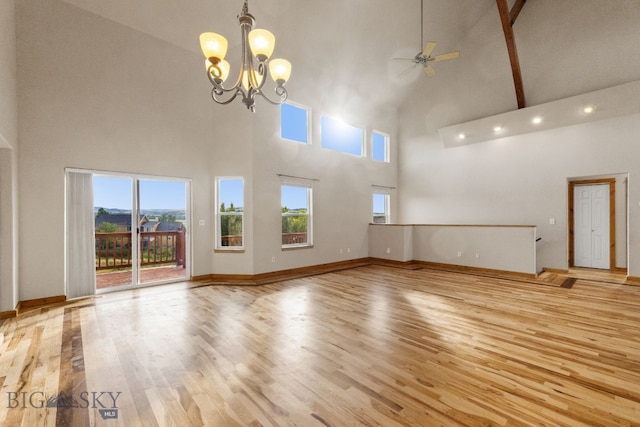 74 W Clara Ct, Bozeman, MT 59718 - unfurnished living room featuring high vaulted ceiling, ceiling fan, wood finished floors, and a chandelier