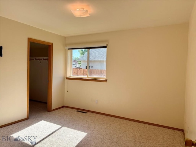 3455 W Cascade, Bozeman, MT 59718 - unfurnished bedroom featuring light colored carpet and a walk in closet