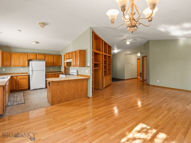 3455 W Cascade, Bozeman, MT 59718 - kitchen featuring freestanding refrigerator, range, vaulted ceiling, light countertops, and a chandelier