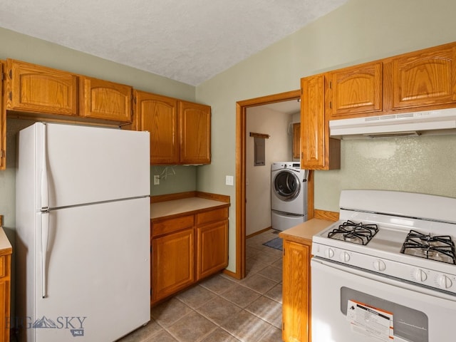 3455 W Cascade, Bozeman, MT 59718 - kitchen featuring white appliances, under cabinet range hood, washer / dryer, light countertops, and dark tile patterned floors