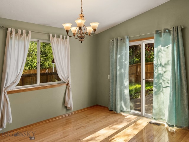 3455 W Cascade, Bozeman, MT 59718 - spare room with a chandelier, wood finished floors, and lofted ceiling