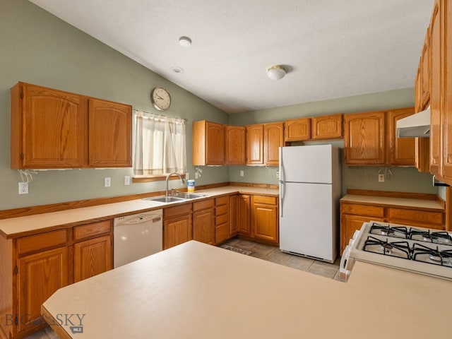 3455 W Cascade, Bozeman, MT 59718 - kitchen with white appliances, under cabinet range hood, lofted ceiling, light countertops, and light tile patterned floors