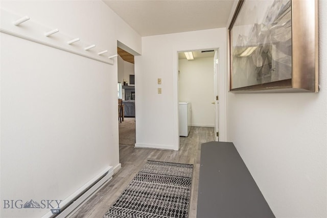 344 Candlelight Meadow Dr, Big Sky, MT 59716 - hall featuring light wood-style floors, washer / dryer, and a baseboard heating unit