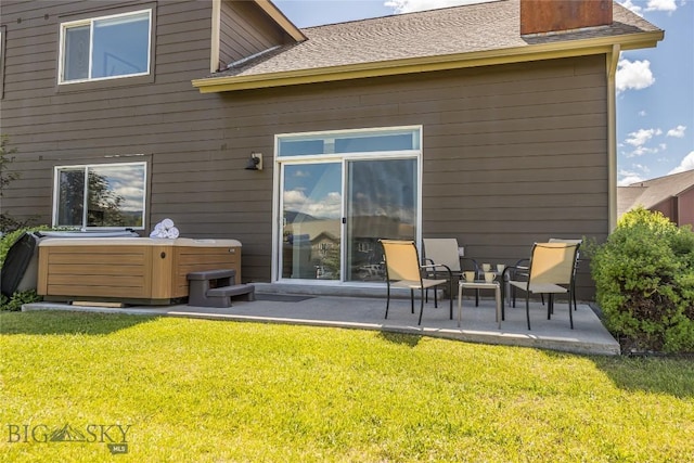 344 Candlelight Meadow Dr, Big Sky, MT 59716 - back of property with a patio area, a hot tub, a yard, and a shingled roof