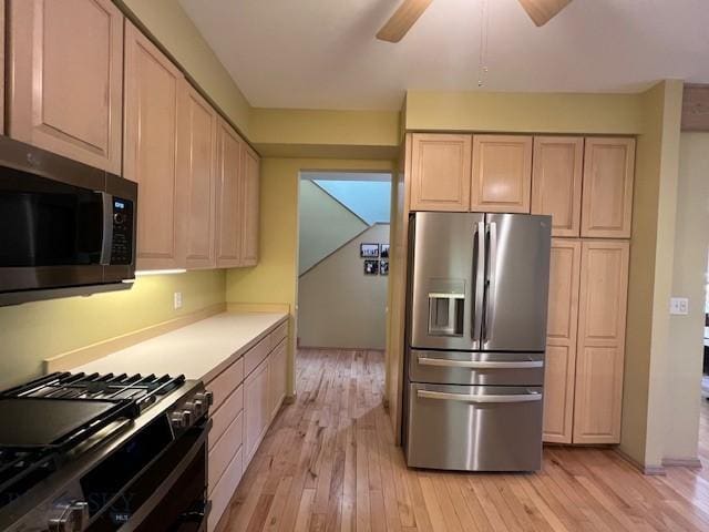 3 Gallatin Unit B, Bozeman, MT 59718 - kitchen with appliances with stainless steel finishes, light wood-style flooring, a ceiling fan, light countertops, and light brown cabinets