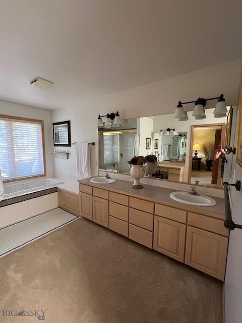 3 Gallatin Unit B, Bozeman, MT 59718 - full bath featuring double vanity, a garden tub, and a stall shower