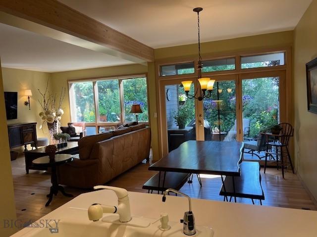 3 Gallatin Unit B, Bozeman, MT 59718 - dining area with wood finished floors, a chandelier, beam ceiling, and french doors