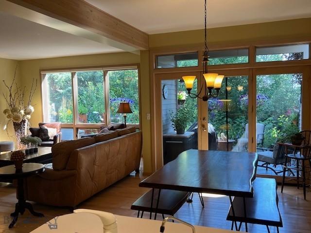 3 Gallatin Unit B, Bozeman, MT 59718 - dining room featuring a chandelier, wood finished floors, and beamed ceiling
