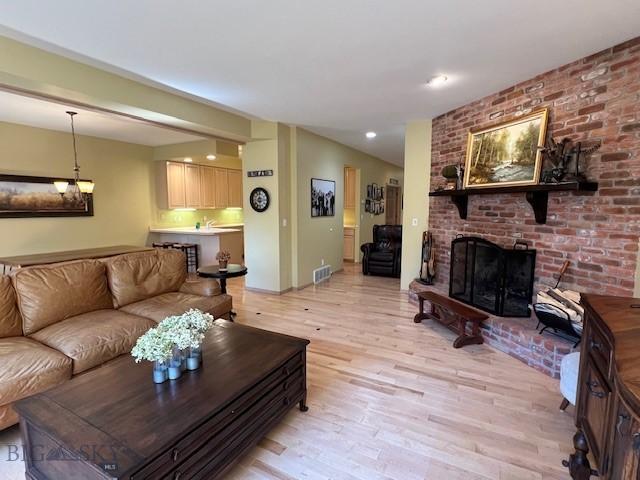 3 Gallatin Unit B, Bozeman, MT 59718 - living area with light wood-type flooring, a brick fireplace, and recessed lighting