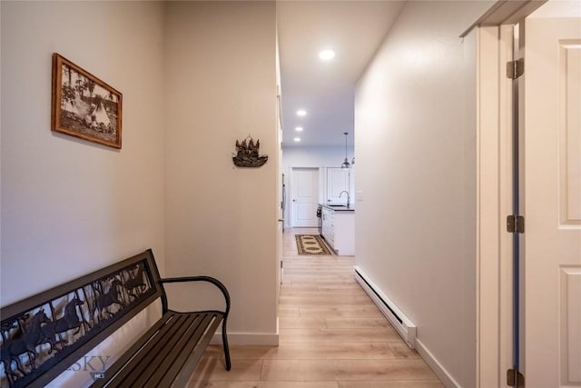 2221D Willow Dr Unit 128, Livingston, MT 59047 - hallway featuring a baseboard radiator, light wood-style floors, and recessed lighting