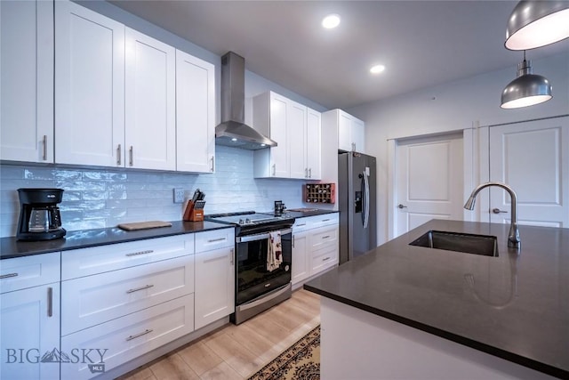 2221D Willow Dr Unit 128, Livingston, MT 59047 - kitchen featuring range with electric cooktop, wall chimney exhaust hood, stainless steel fridge with ice dispenser, dark countertops, and decorative backsplash