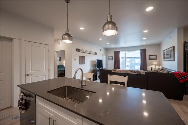 2221D Willow Dr Unit 128, Livingston, MT 59047 - kitchen featuring open floor plan, dark countertops, white cabinets, dishwasher, and pendant lighting