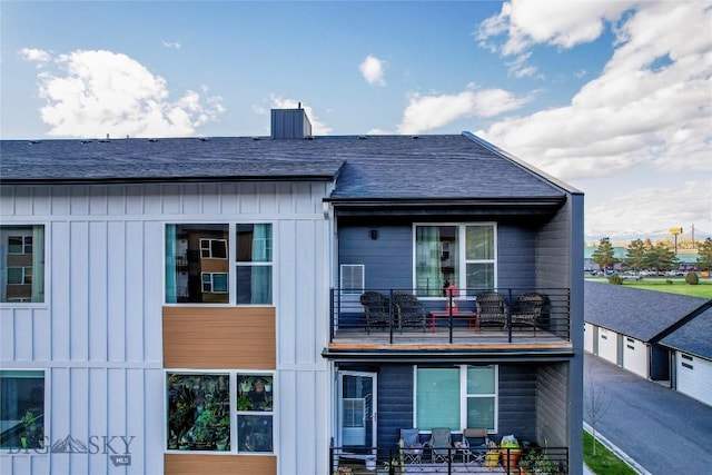 2221D Willow Dr Unit 128, Livingston, MT 59047 - rear view of property with a balcony, board and batten siding, and a detached garage