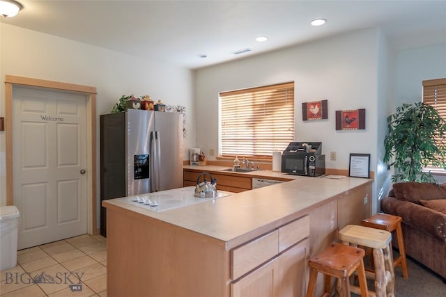 2221D Willow Dr Unit 128, Livingston, MT 59047 - kitchen with electric stovetop, stainless steel refrigerator with ice dispenser, light countertops, black microwave, and a peninsula