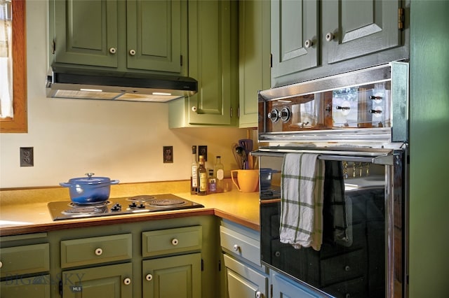 716 W Pine St, Missoula, MT 59802 - kitchen with under cabinet range hood, green cabinetry, and light countertops