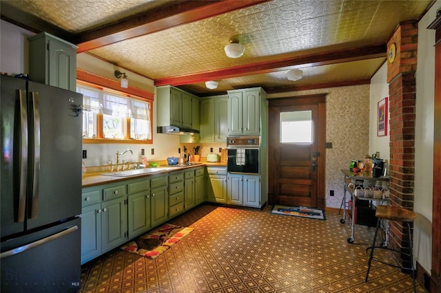 716 W Pine St, Missoula, MT 59802 - kitchen with black appliances, green cabinetry, under cabinet range hood, an ornate ceiling, and light countertops