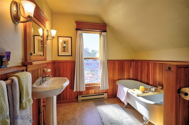 716 W Pine St, Missoula, MT 59802 - bathroom with a baseboard heating unit, lofted ceiling, a soaking tub, wooden walls, and wainscoting