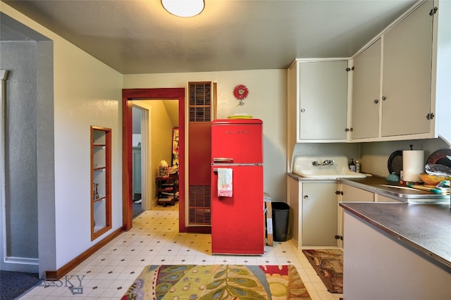 716 W Pine St, Missoula, MT 59802 - kitchen with fridge, a heating unit, light flooring, and dark countertops