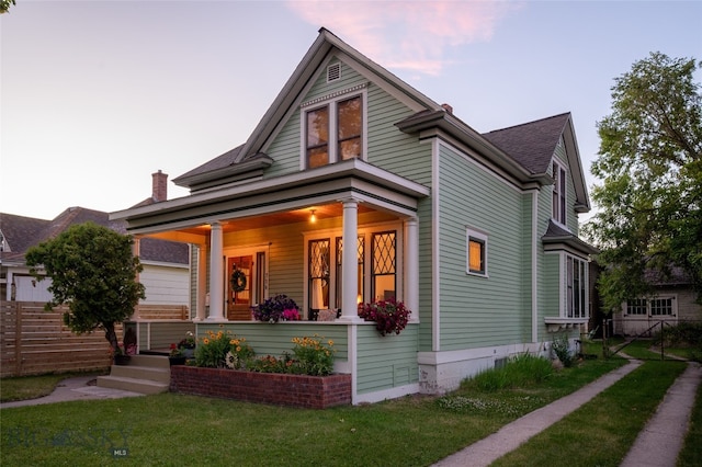 716 W Pine St, Missoula, MT 59802 - victorian home with covered porch, a front lawn, and roof with shingles