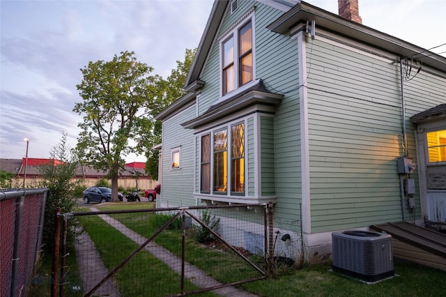 716 W Pine St, Missoula, MT 59802 - view of home's exterior with a cooling unit and a chimney