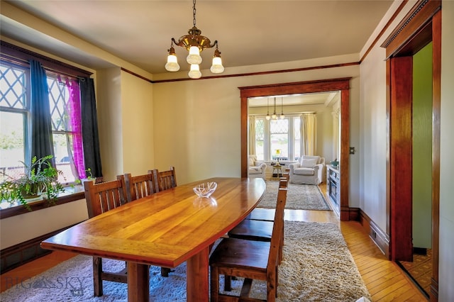 716 W Pine St, Missoula, MT 59802 - dining room with a chandelier and light wood-type flooring