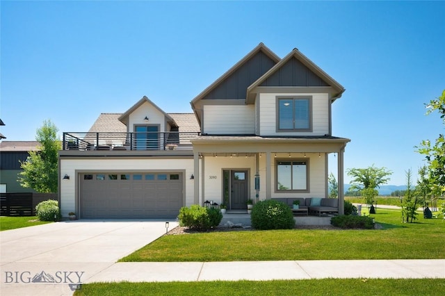 3090 Meah Ln, Bozeman, MT 59718 - view of front facade featuring a porch, board and batten siding, a front lawn, a balcony, and driveway