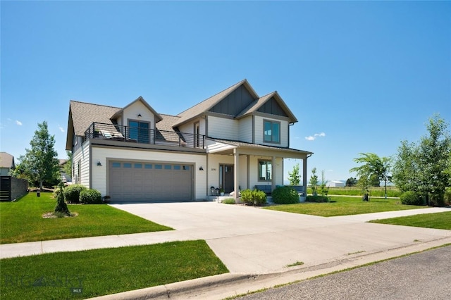 3090 Meah Ln, Bozeman, MT 59718 - view of front of property with a balcony, board and batten siding, a garage, and a front yard