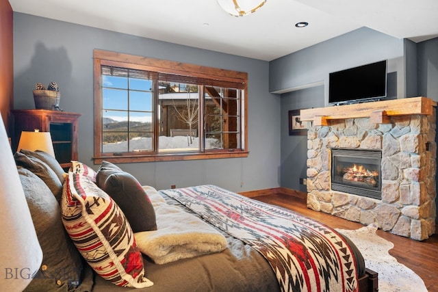 58 Upper Moose Hill Rd, Big Sky, MT 59716 - bedroom with a fireplace, wood finished floors, and recessed lighting