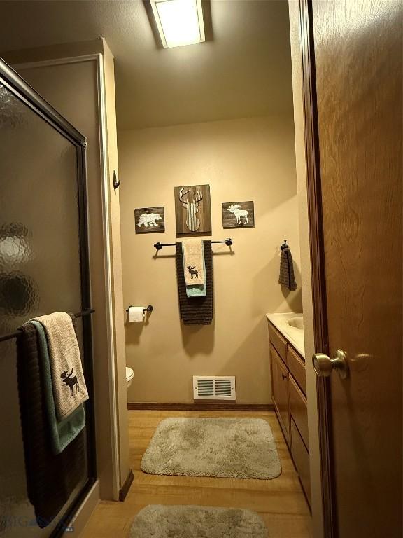 19970 Mt Highway 91 N, Glen, MT 59732 - full bath with wood finished floors, vanity, and an enclosed shower