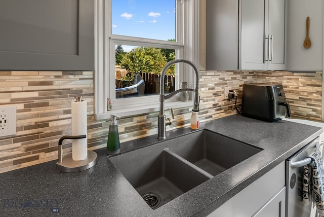 531 N Main St, Livingston, MT 59047 - kitchen view of tasteful backsplash, dark countertops, and dishwasher