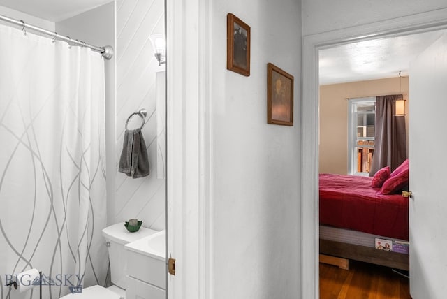 531 N Main St, Livingston, MT 59047 - full bath with wood finished floors, curtained shower, ensuite bathroom, and vanity