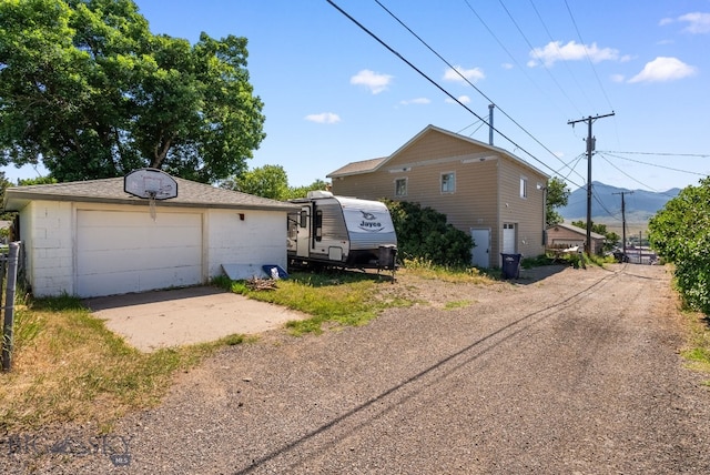 531 N Main St, Livingston, MT 59047 - view of side of property with a detached garage, an outdoor structure, and driveway