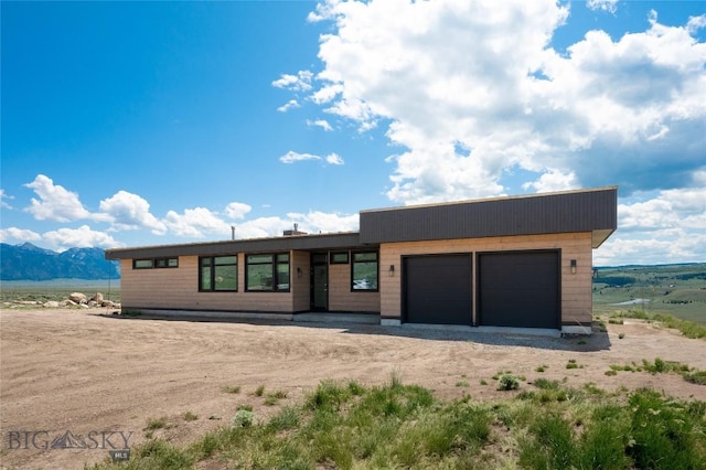 28 Elk Meadows Ranch Rd, Cameron, MT 59720 - view of front facade featuring an attached garage, a mountain view, and driveway