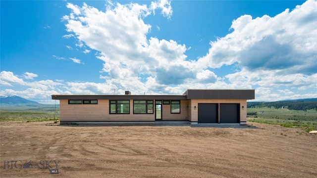 28 Elk Meadows Ranch Rd, Cameron, MT 59720 - view of front facade with an attached garage, driveway, and a mountain view