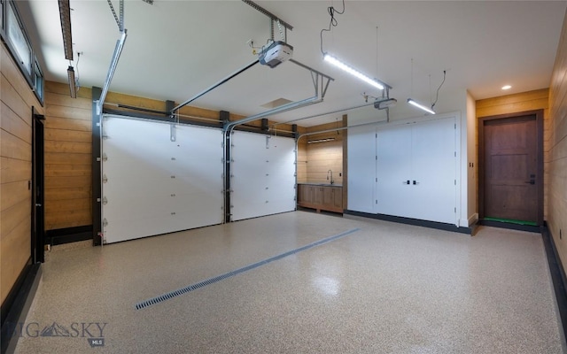 28 Elk Meadows Ranch Rd, Cameron, MT 59720 - garage with a garage door opener and wooden walls