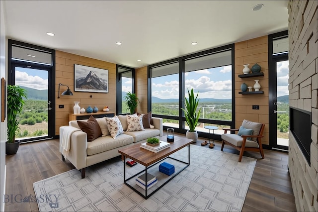 28 Elk Meadows Ranch Rd, Cameron, MT 59720 - living area with floor to ceiling windows, wood finished floors, wood walls, recessed lighting, and a fireplace