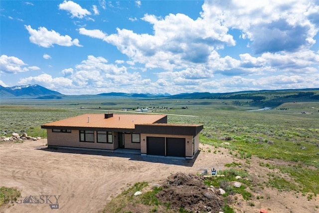 28 Elk Meadows Ranch Rd, Cameron, MT 59720 - view of front of house with an attached garage, a mountain view, driveway, and a metal roof