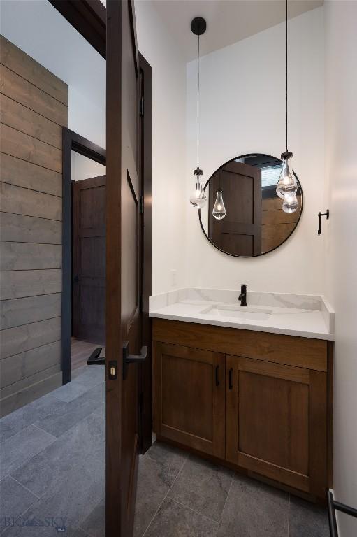 28 Elk Meadows Ranch Rd, Cameron, MT 59720 - bathroom featuring vanity, tile patterned floors, and wood walls